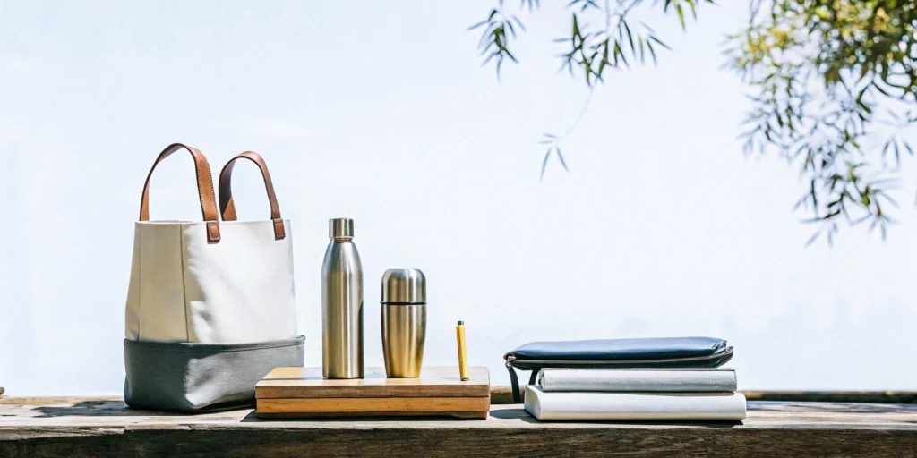 Sustainable corporate merchandise display featuring eco-friendly branded products on a natural wood table