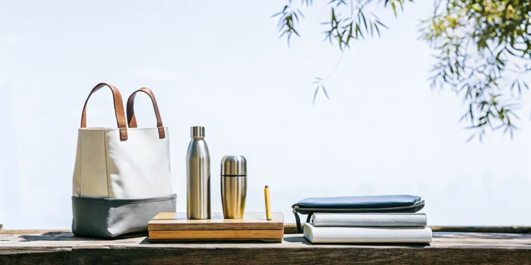 Sustainable corporate merchandise display featuring eco-friendly branded products on a natural wood table